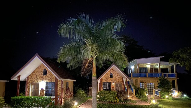 A two-story building with a stone facade and a balcony. - El Gran Mestizo Resort (Orange Walk)