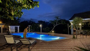 An outdoor swimming pool area with lounge chairs and a brick patio. - El Gran Mestizo Resort (Orange Walk)