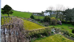 A rural landscape with a white house, stone walls, and a grassy field. - Portling View -  an apartment that sleeps 6 guests  in 3 bedrooms (Dalbeattie)