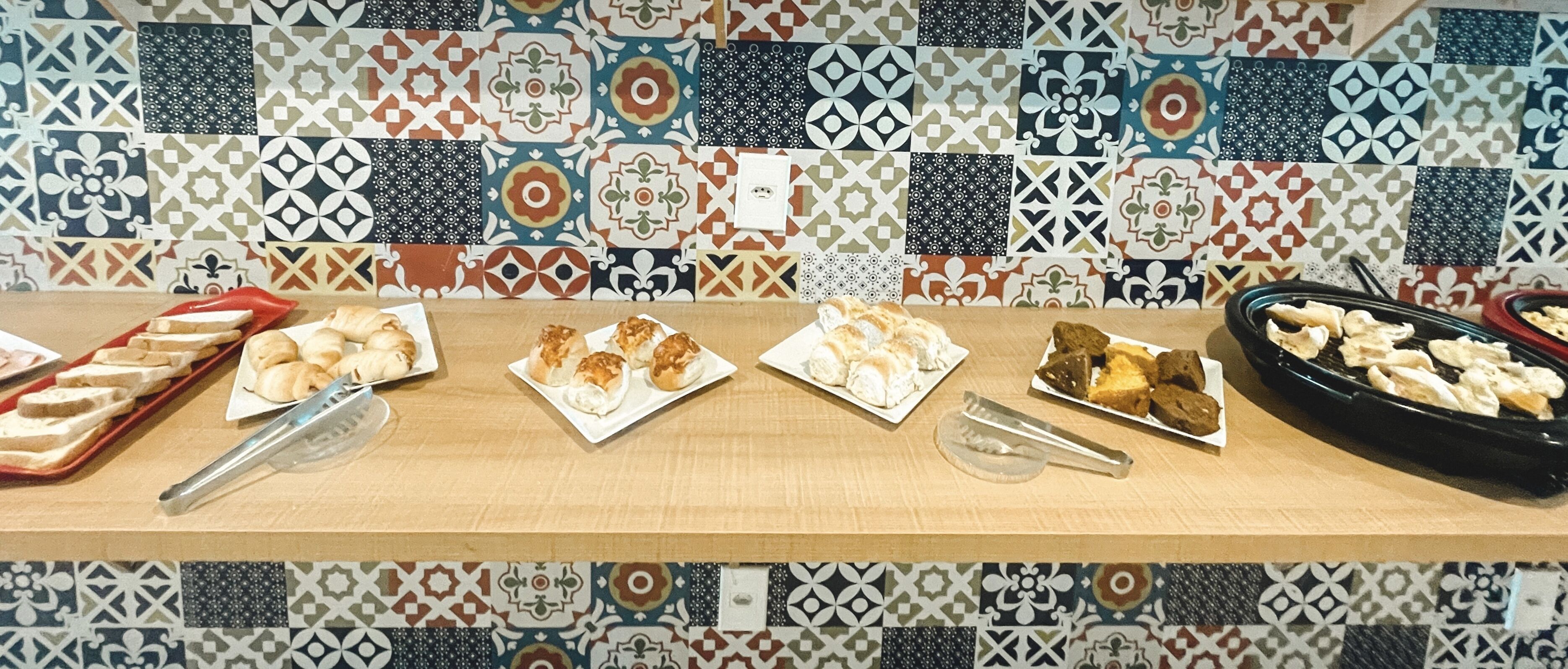 Una mesa de buffet con diversos alimentos y utensilios para servir.