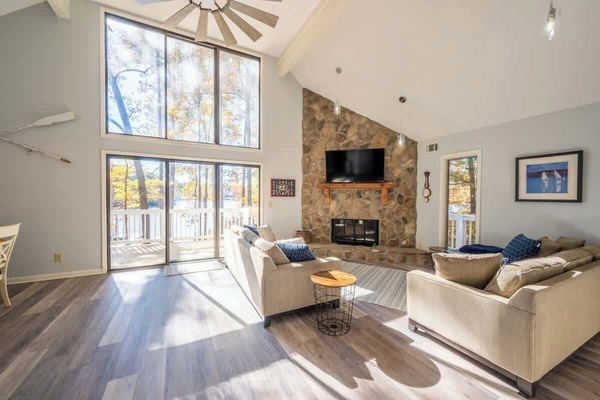 Main Living Area With Stone Fireplace & View Of The Lake