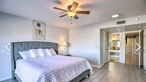 A bedroom with a large bed, a ceiling fan, and a nightstand with a lamp. - Beautiful 4 bedroom 2 bathroom with pool and pool table for your entertainment (Glendale)
