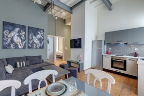 A modern apartment with a living area, dining space, and kitchen.