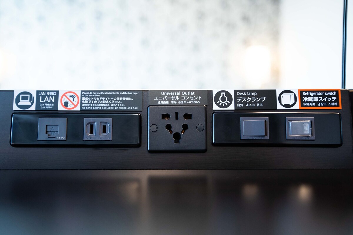 A power outlet with multiple sockets, a universal outlet, and a refrigerator switch.
