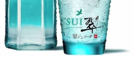 A bottle of Suntory Gin and a glass with ice.