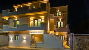 A multi-story hotel with a modern design, featuring balconies and a staircase leading to the entrance. - Amara Suites and Studios (Hersonissos)