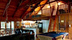 A rustic interior with a pool table, wooden furniture, and a kitchen area. - Rustic newly remodeled River House on working fish house property . Gulf access (Inglis)
