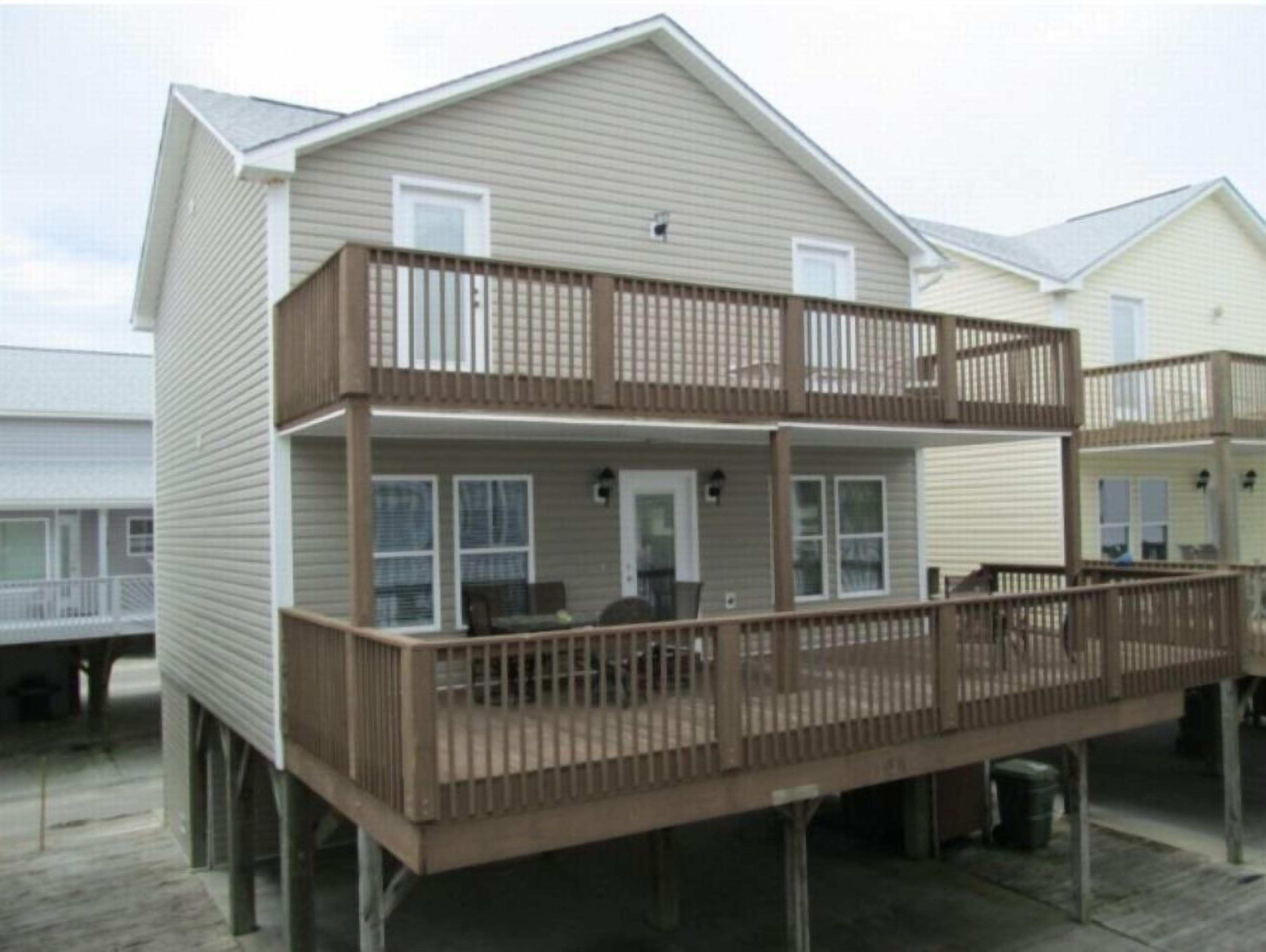 A two-story house with a balcony on the ground floor.