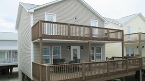 A two-story house with a balcony on the ground floor. - Book now for the SUMMER before it’s gone @ Ocean Lakes Family Campground!! (Myrtle Beach)