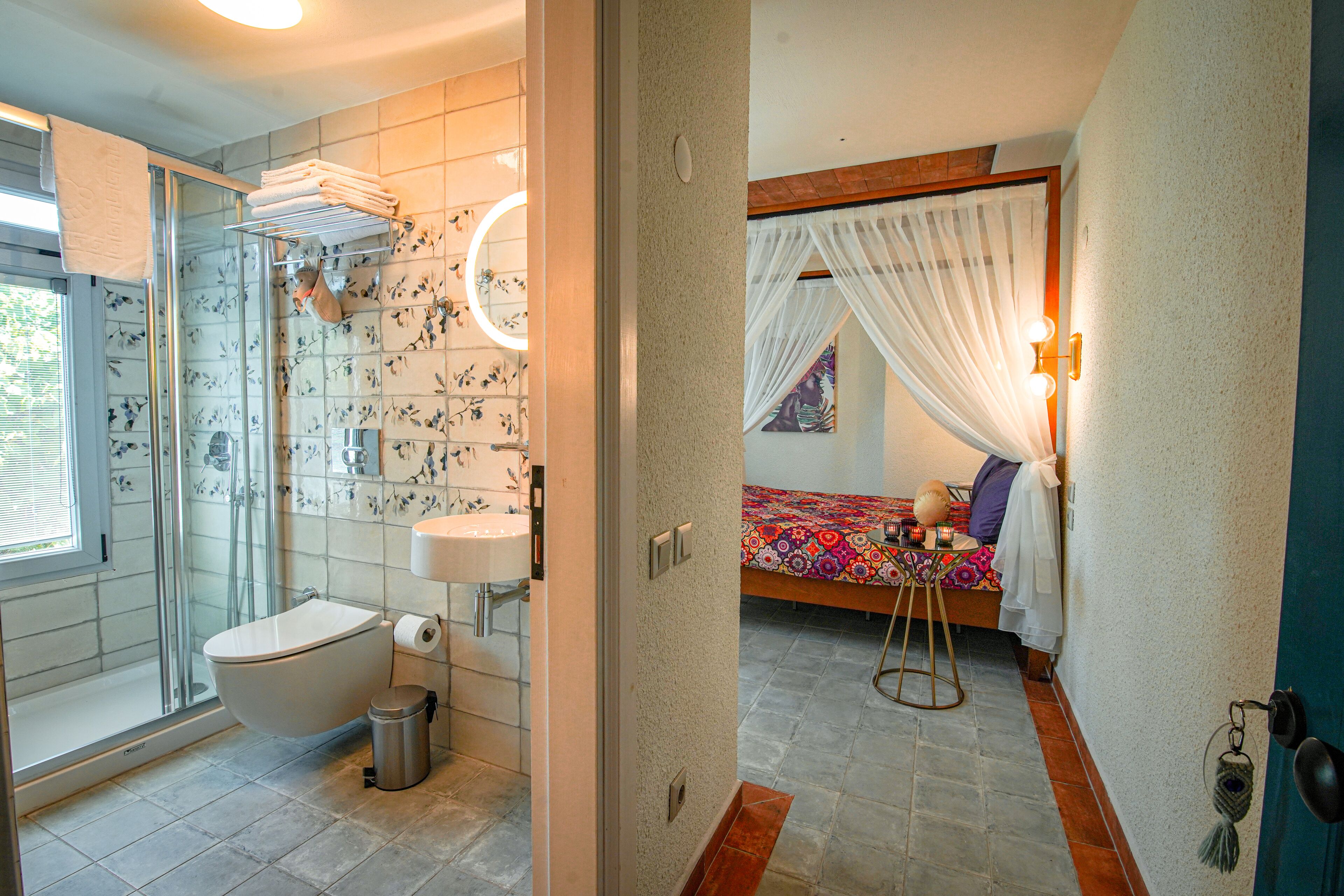 A bathroom with a shower, toilet, and sink.