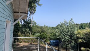 A wooden building with a porch, a fenced outdoor area, and a view of a forested landscape. - 3Bed Maisonette/close to beach/Tranquil  (Seignosse)