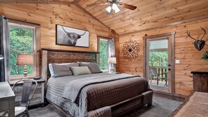 A wooden cabin bedroom with a bed, desk, chair, and a ceiling fan. - Stunning Mountain Modern Retreat! 3-Story/Location/Gameroom/Fireplace/Creek (Blue Ridge)