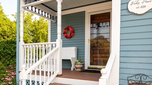 A porch with white railings, a wooden staircase, a door with a wreath, and a sign stating "Holly House est. 1880". - Beautiful Victorian with Modern Flare close to Town, Train & Beach (Ipswich)