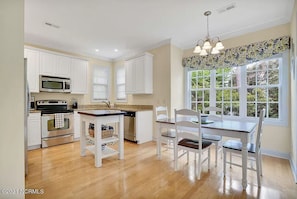 Enjoy meals in the kitchen with a dining area and window view of the surrounding greenery.