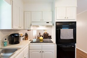 Coffee/tea maker, cookware/dishes/utensils, dining tables