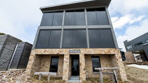 A modern building with a stone facade and a sign reading "WHITEMOUNT".