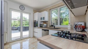 A modern kitchen with a gas stove, microwave, and toaster.