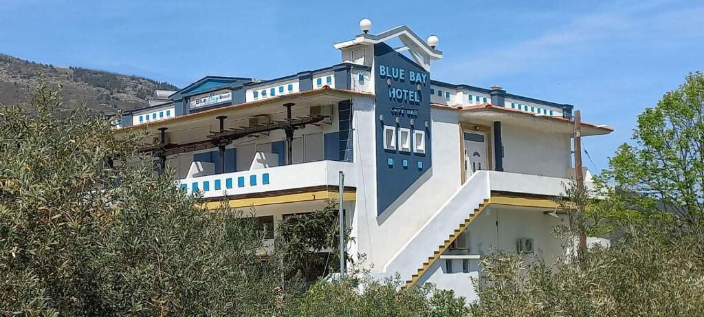 A two-story Blue Bay Hotel with a prominent entrance and a bar area.
