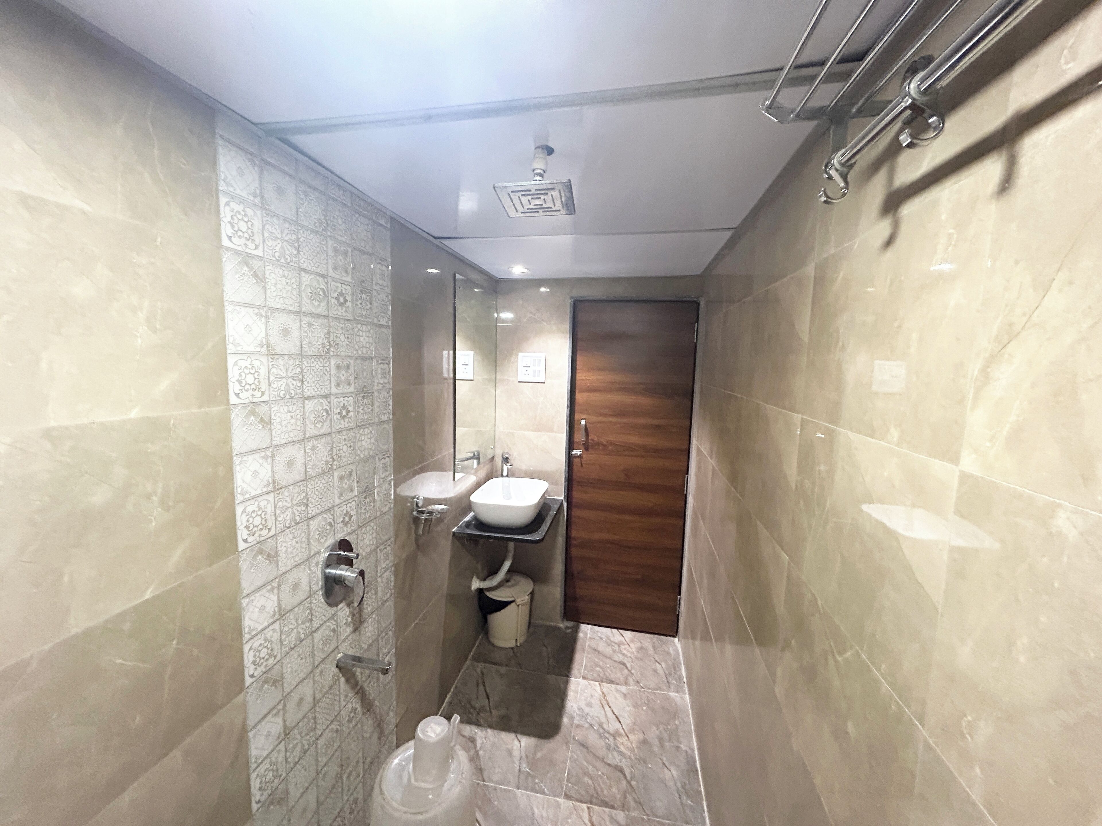 A bathroom with two sinks, a shower, and a toilet.