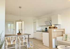 Fridge, stovetop, dishwasher, coffee/tea maker