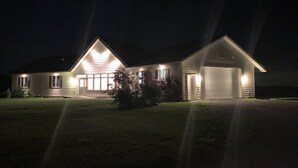 A two-story house with a garage, illuminated by exterior lights. - Private,Spacious House near Howes Cavern (Carisle)