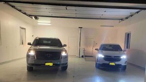 A parking garage with two cars parked side by side. - Private,Spacious House near Howes Cavern (Carisle)