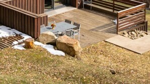 A wooden cabin with a red roof, a deck, and a view of the surrounding hills. - Incredible Chalet in the Southern Vosges (Alsace) (Lautenbach)