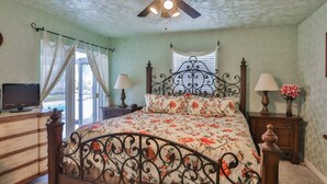 A bedroom with a bed, ceiling fan, bedside lamps, and a television on a dresser. - Seminole Comfort: Private Pool Home - 3BD/2BA (Private Homes)