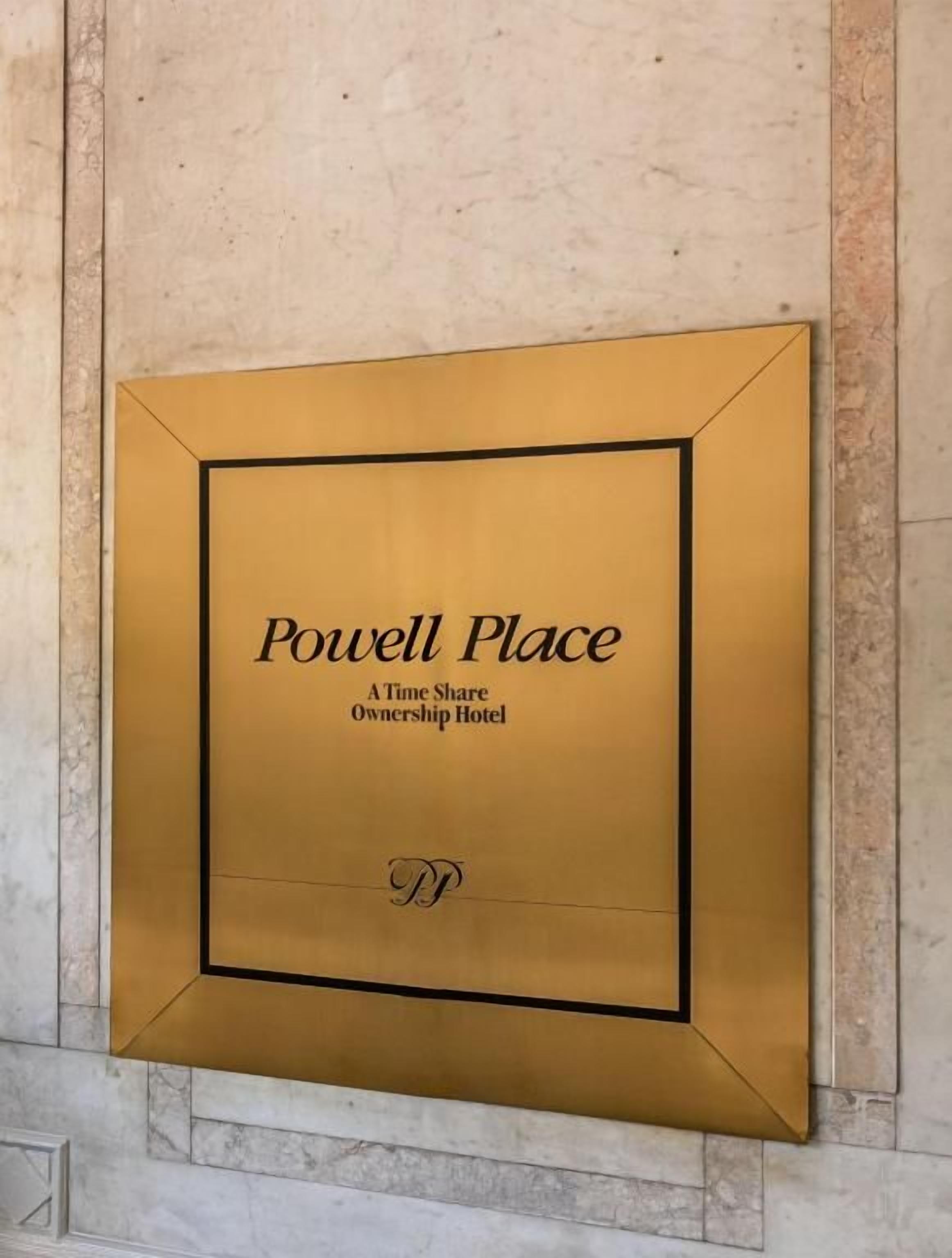 A plaque with the text 'Powell Place' and 'A Time Share Ownership Hotel' on a wall.