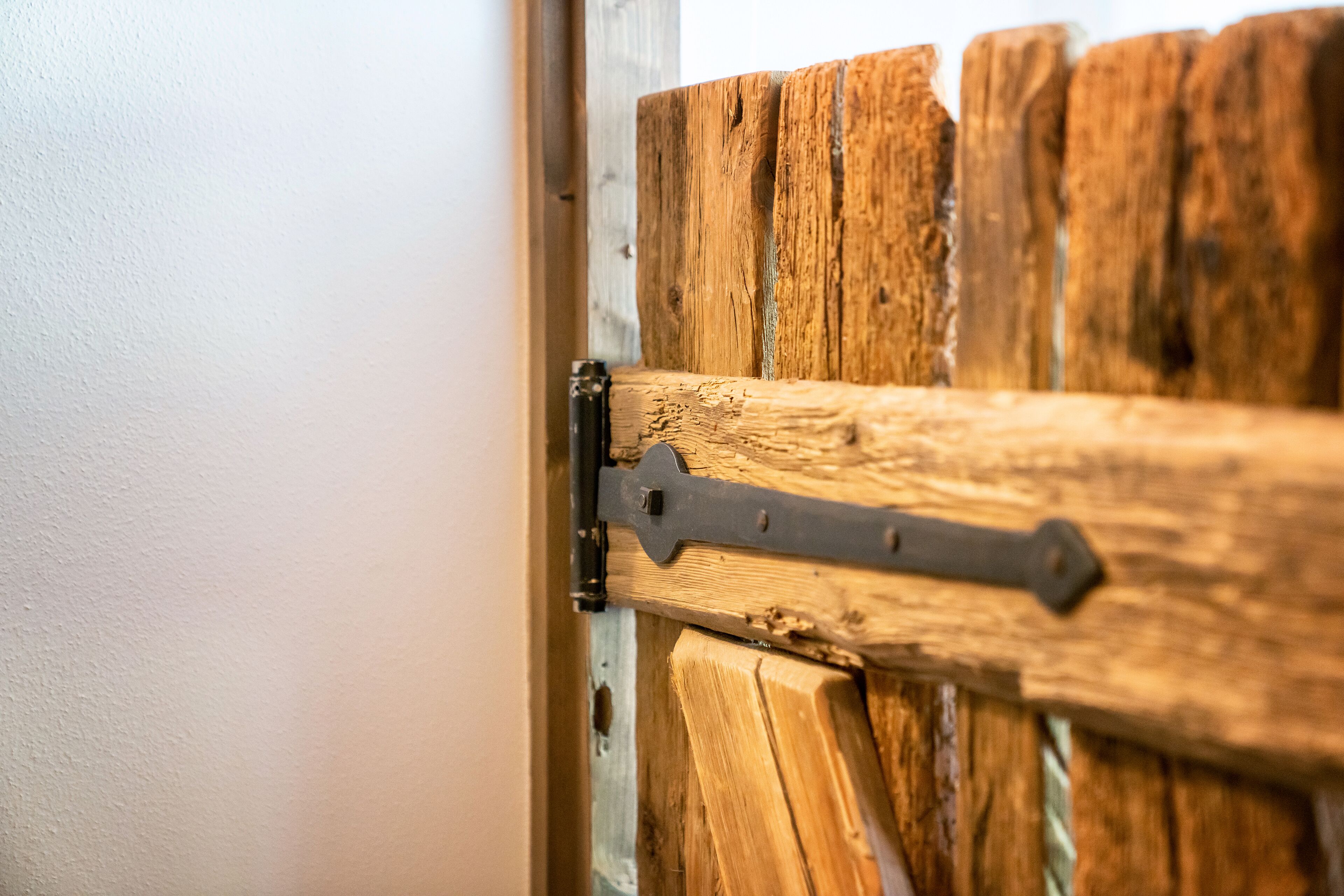 A wooden door with a metal latch.