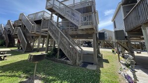 A wooden structure with multiple levels and staircases, likely part of a building or complex. - Come and Relax at Paradise Found! (HATTERAS)