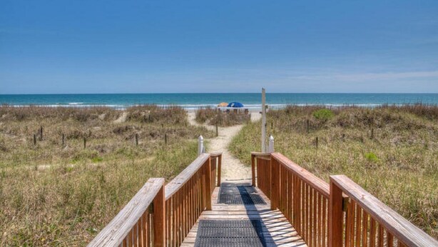 A wooden boardwalk leading to a beach with a clear view of the ocean. - Tidemaster 402-3BR/3BA Oceanfront condo in Ocean Drive (North Myrtle Beach)