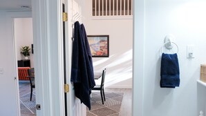 A bathroom with a white sink, a towel rack with a blue towel, and a framed picture on the wall. - Beautiful new guest cottage, perfect for families! (Hayden)