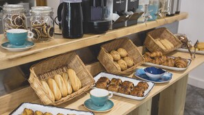 A breakfast buffet with various baked goods, pastries, and a coffee station. - Hotel la Caracola Suances (Suances)