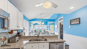 A modern kitchen with granite countertops, stainless steel appliances, and a dishwasher. - "Waters Edge 427-A" - Oceanfront Condo w/ Community Pool, 2 Bedrooms / 2 Bathrooms (Holden Beach)