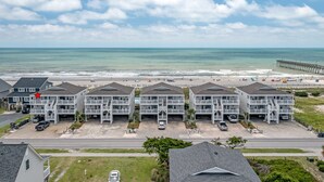 A beachfront hotel with multiple buildings, a pier, and a beach in the background. - "Waters Edge 427-A" - Oceanfront Condo w/ Community Pool, 2 Bedrooms / 2 Bathrooms (Holden Beach)