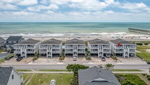 A beachfront hotel with multiple buildings, a pier, and a beach in the background. - "Waters Edge 435-A" - Oceanfront Condo w/ Community Pool, 2 Bedrooms / 2 Bathrooms (Holden Beach)