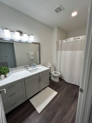 Combined shower/bathtub, towels, toilet paper
