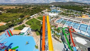 A water park with multiple slides and a swimming pool.