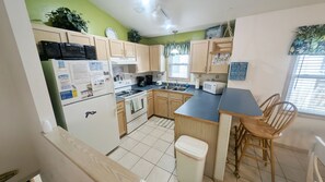 Enjoy cooking in this fully equipped kitchen with a central island, stove, oven, refrigerator, and appliances.