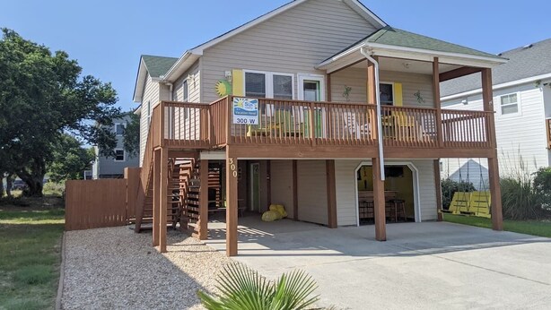A two-story house with a covered porch and a small deck. - West Side Near Avalon Pier ~ Hot Tub~Dog Friendly~Firepit + Fenced in Yard (Kill Devil Hills)