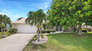 Situated in a suburban neighborhood, this single-story house features a garage and well-manicured lawns.