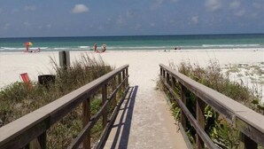 A beach pathway leading to the shore with a clear view of the ocean and beachgoers. - Belleview Gulf Studio/Steps away from BEACH (378) (Indian Shores)