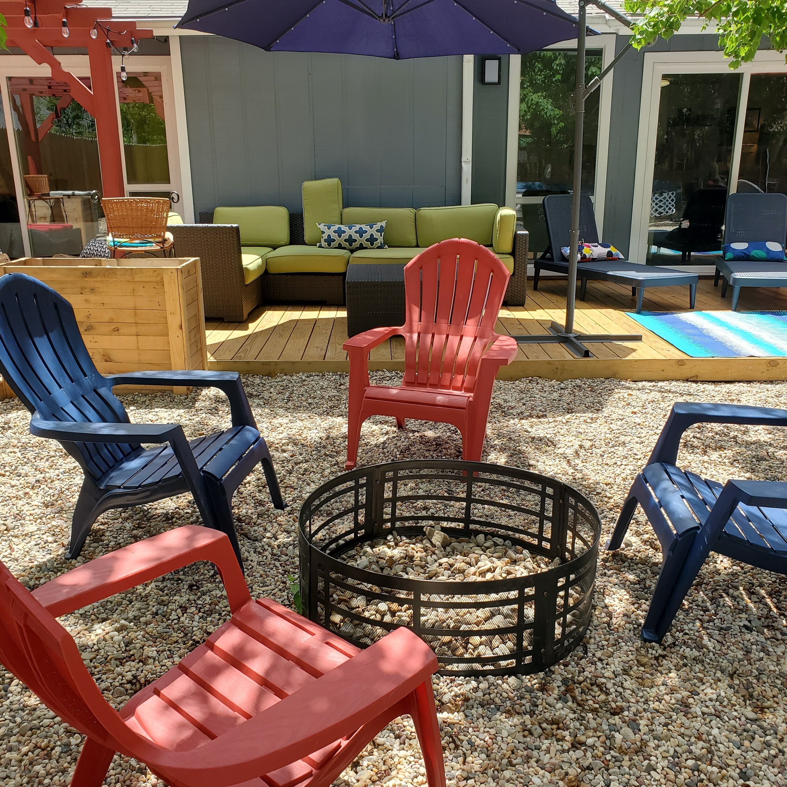 A patio area with outdoor furniture, including chairs and a sofa, and a fire pit.