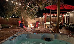 A backyard with a fire pit, outdoor seating, and a hot tub. - Party with a Jaccuzzi, Firepit and Backyard Games for 12+ (Austin)
