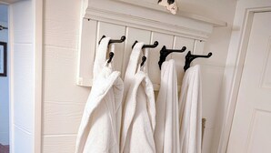 A bathroom with white towels hanging on a rack and a black floor lamp. - Bill's Landing Luxury Suite with private Hot Tub (Gibsons)