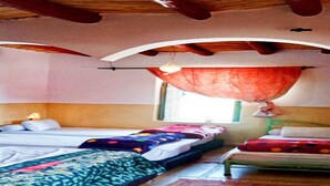 A room with two beds, a window with a curtain, and a wooden ceiling. - DAR BOUMIDA 5423 Lalla Takerkoust (Lalla Takerkoust)