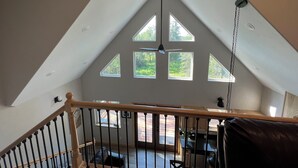 A high-ceilinged room with a sloped roof, skylight windows, and a ceiling fan. - Built in 2021. Beautiful Wooded Lot.  Minutes to Kenai, Soldotna & Kasiloff. (Soldotna)