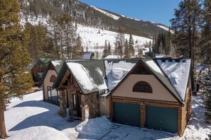 Escape to a rustic alpine retreat amidst a serene forested mountain backdrop.