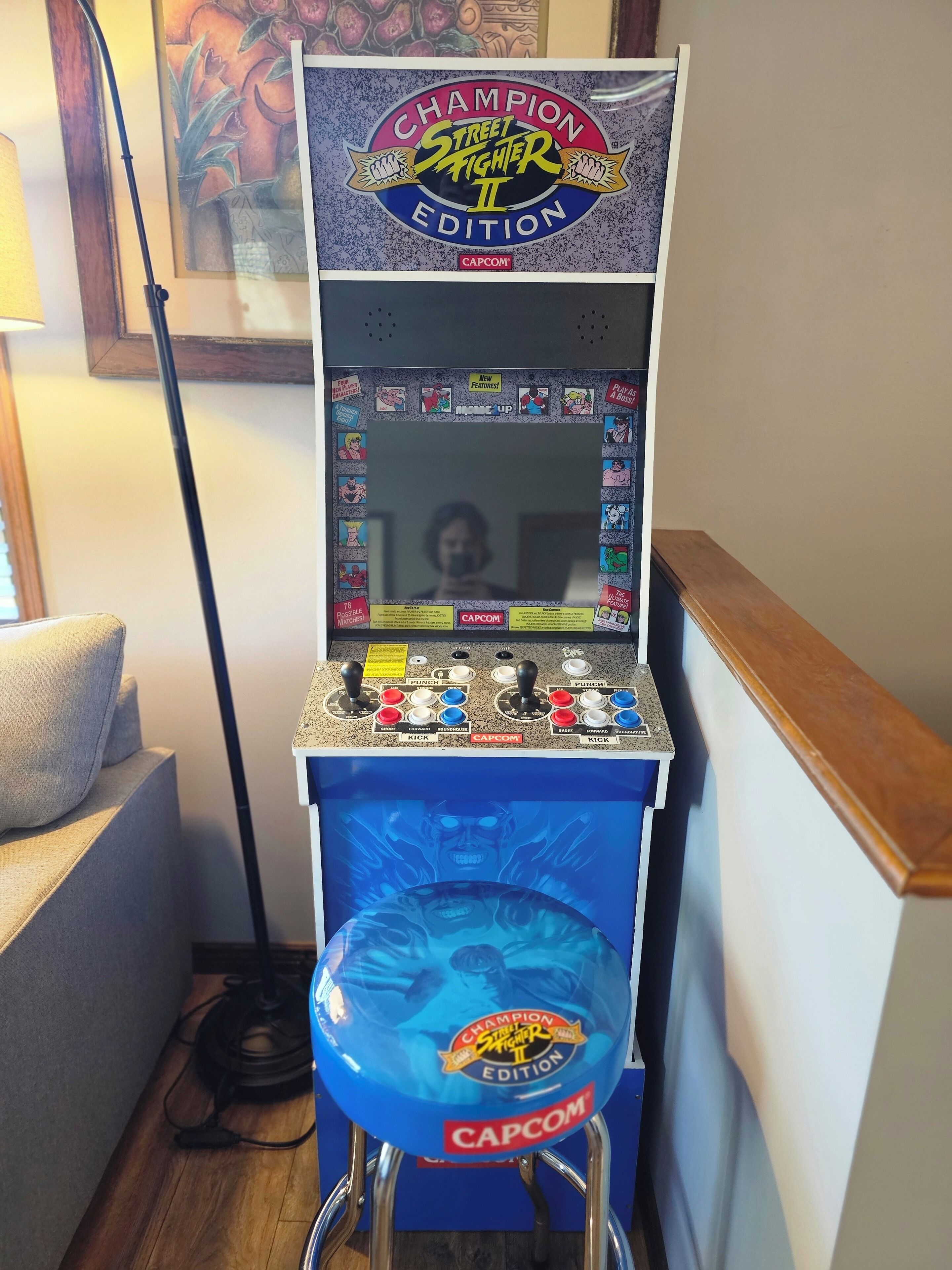 A Champion Street Fighter II arcade machine with a blue seat and control panel.